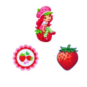 apliques sublimados do tema Moranguinho: menina sentada no morango, medalhão decorativo e morango vermelho.