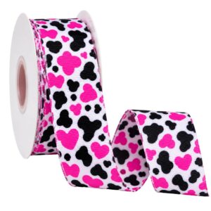 Rolo de fita de gorgurão branca com estampa animal print em rosa-pink e preto, parcialmente desenrolado.